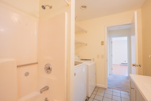19 Somers St Unit D1, Danbury, CT 06810 - laundry room with light tile patterned floors, washer and clothes dryer, a baseboard heating unit, and light carpet