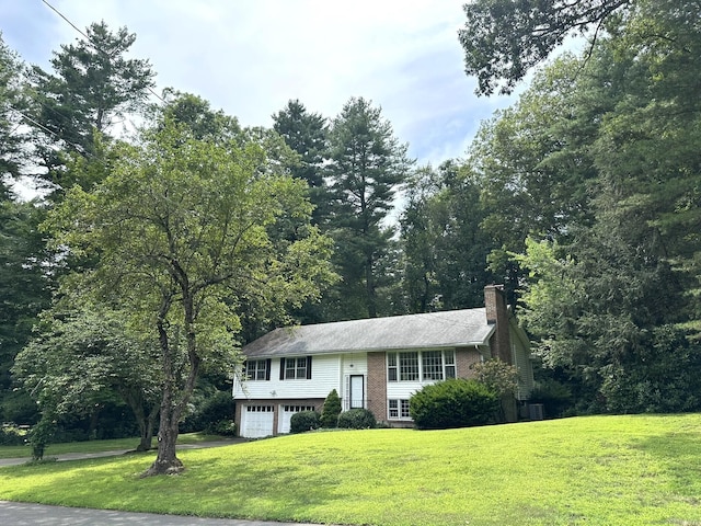 51 Westridge Dr, Avon, CT 06001 - raised ranch featuring a garage, a chimney, a front lawn, and brick siding