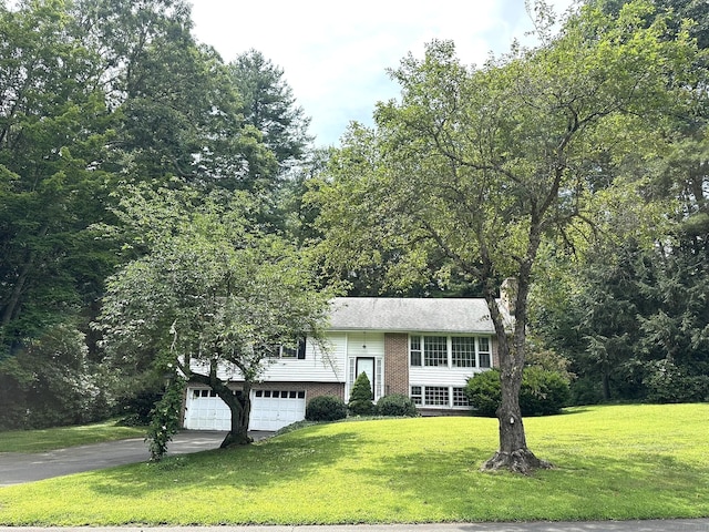 51 Westridge Dr, Avon, CT 06001 - bi-level home with a front lawn, a garage, driveway, a chimney, and brick siding