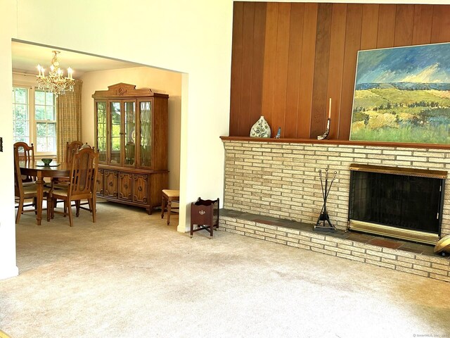 51 Westridge Dr, Avon, CT 06001 - carpeted living area with a chandelier, wood walls, and a brick fireplace