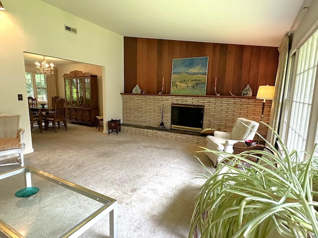 51 Westridge Dr, Avon, CT 06001 - carpeted living room with a chandelier, wooden walls, and a brick fireplace