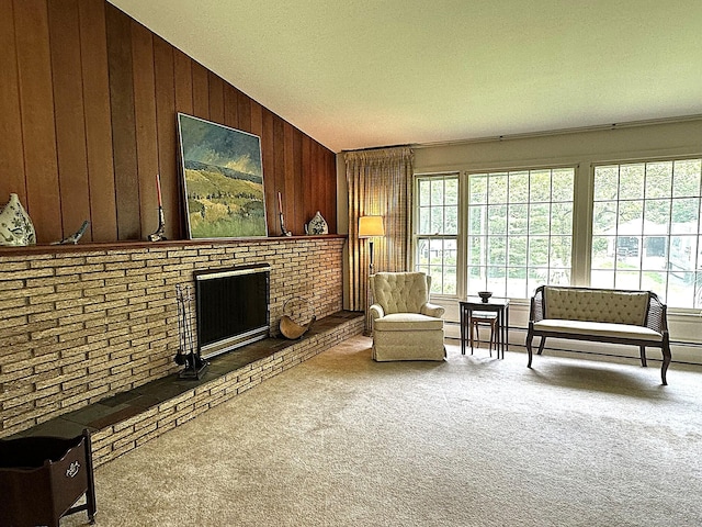 51 Westridge Dr, Avon, CT 06001 - living area with wood walls, healthy amount of natural light, vaulted ceiling, carpet floors, and a brick fireplace