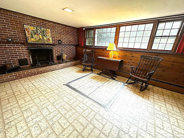51 Westridge Dr, Avon, CT 06001 - living area with healthy amount of natural light, a fireplace, brick patterned flooring, wood walls, and brick wall