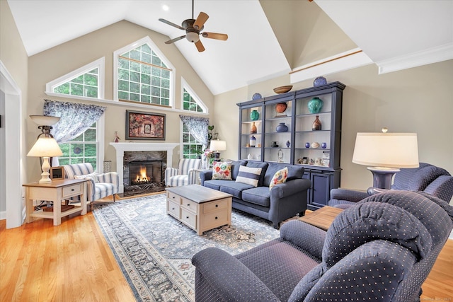 24 Windflower Ln, Shelton, CT 06484 - living area with a ceiling fan, light wood-style floors, a premium fireplace, and high vaulted ceiling