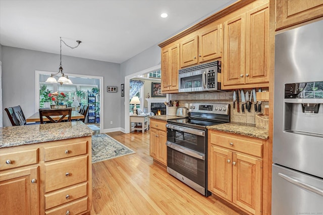 24 Windflower Ln, Shelton, CT 06484 - kitchen with appliances with stainless steel finishes, light wood-type flooring, backsplash, light stone countertops, and recessed lighting