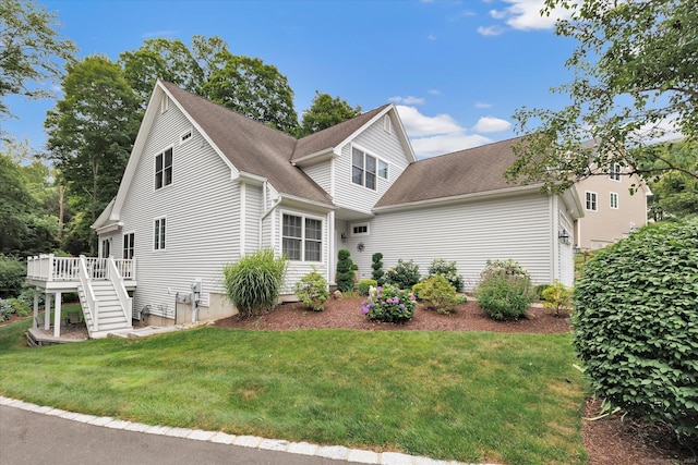 24 Windflower Ln, Shelton, CT 06484 - view of front of property featuring a deck, stairs, a front lawn, and roof with shingles