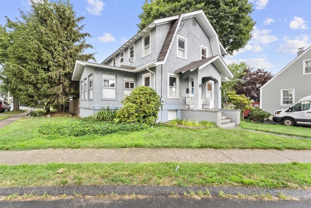 1276 N Ave, Stratford, CT 06614 - dutch colonial featuring stucco siding, roof with shingles, a front yard, and a gambrel roof
