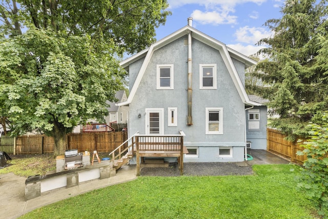 1276 N Ave, Stratford, CT 06614 - back of property with stucco siding, a fenced backyard, and an outdoor kitchen