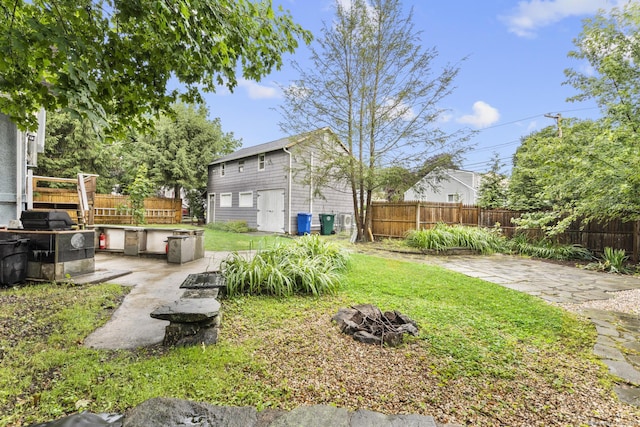 1276 N Ave, Stratford, CT 06614 - fenced backyard with a fire pit, a patio, and an outbuilding