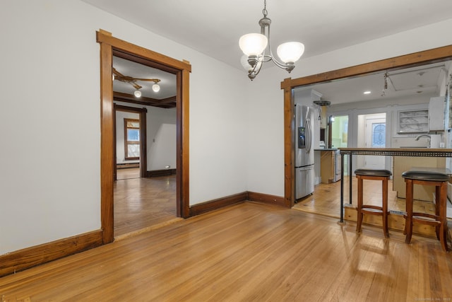 1276 N Ave, Stratford, CT 06614 - dining room featuring light wood-style flooring and a chandelier