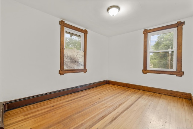 1276 N Ave, Stratford, CT 06614 - empty room with a baseboard radiator, light wood finished floors, and plenty of natural light