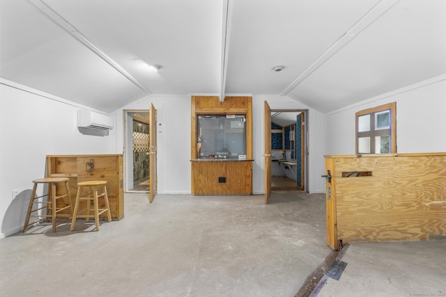 1276 N Ave, Stratford, CT 06614 - living room with a wall mounted air conditioner, vaulted ceiling, and concrete floors