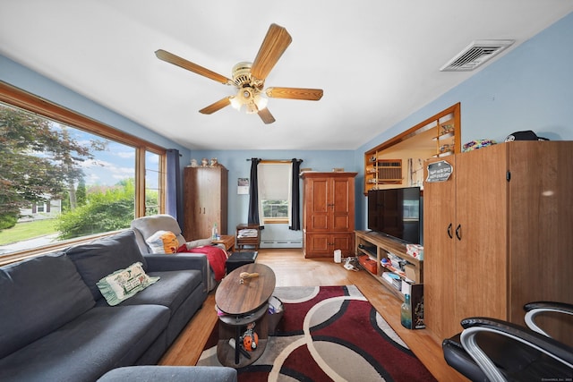 211 Pembroke Ave, Waterbury, CT 06704 - living area featuring a ceiling fan, a baseboard heating unit, and light wood finished floors