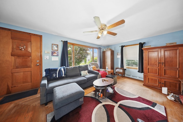 211 Pembroke Ave, Waterbury, CT 06704 - living area with a baseboard radiator, ceiling fan, and light wood-style floors