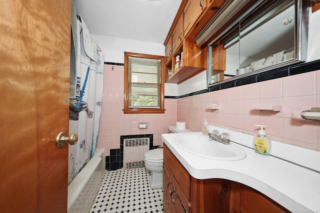 211 Pembroke Ave, Waterbury, CT 06704 - bathroom with radiator heating unit, tile walls, vanity, shower / bath combination with curtain, and tile patterned floors