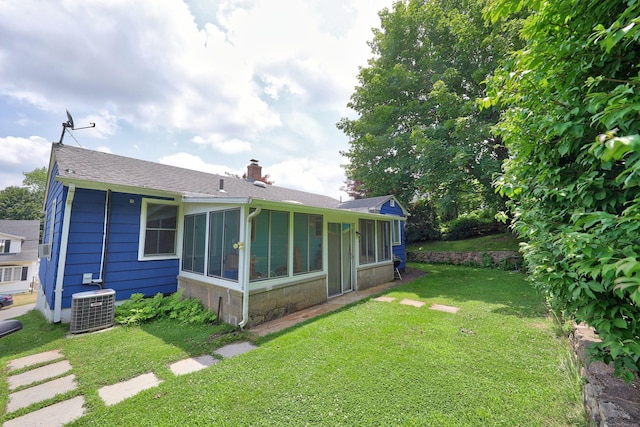 211 Pembroke Ave, Waterbury, CT 06704 - back of house with a yard, a chimney, a sunroom, and roof with shingles