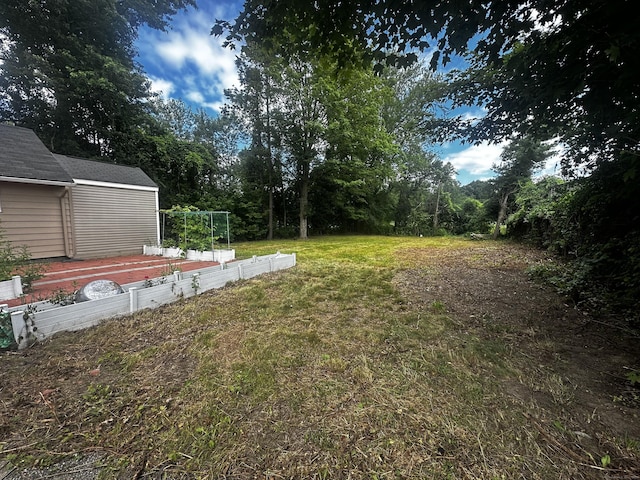 855 Thompsonville Rd, Suffield, CT 06078 - view of grassy yard featuring a garden and a storage shed