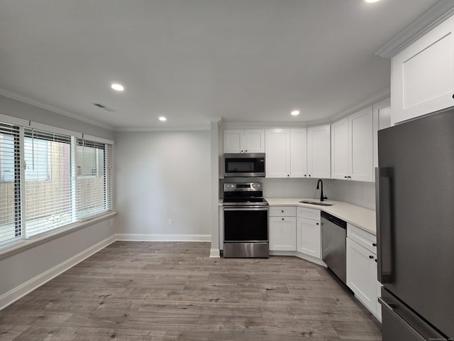 112 Glenwood Ave Unit 112, Bridgeport, CT 06610 - kitchen with stainless steel appliances, recessed lighting, crown molding, light countertops, and white cabinetry
