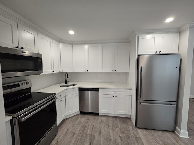 112 Glenwood Ave Unit 112, Bridgeport, CT 06610 - kitchen with appliances with stainless steel finishes, light wood-type flooring, white cabinetry, light countertops, and recessed lighting