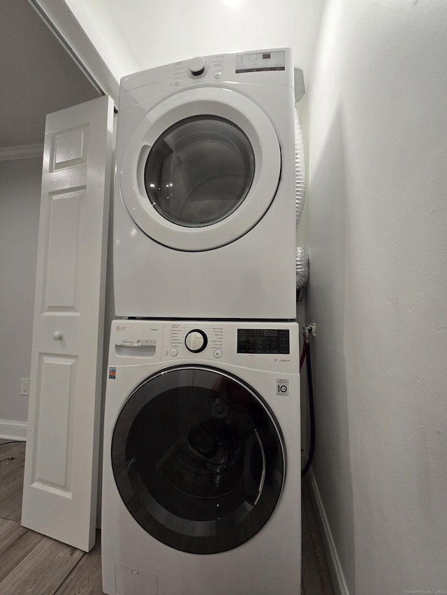 112 Glenwood Ave Unit 112, Bridgeport, CT 06610 - laundry room featuring stacked washer and clothes dryer and wood finished floors