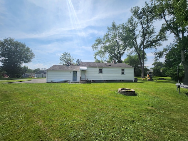 5 Cascio Rd, Ansonia, CT 06401 - rear view of property with a fire pit, a lawn, a playground, a trampoline, and entry steps