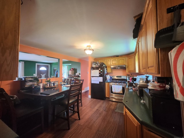5 Cascio Rd, Ansonia, CT 06401 - kitchen with stainless steel range with gas stovetop, freestanding refrigerator, range hood, dark wood-style flooring, and dark countertops