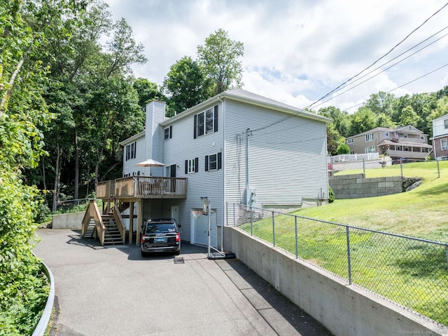 145 Manners Ave, Naugatuck, CT 06770 - rear view of property featuring stairway, driveway, a deck, and a chimney