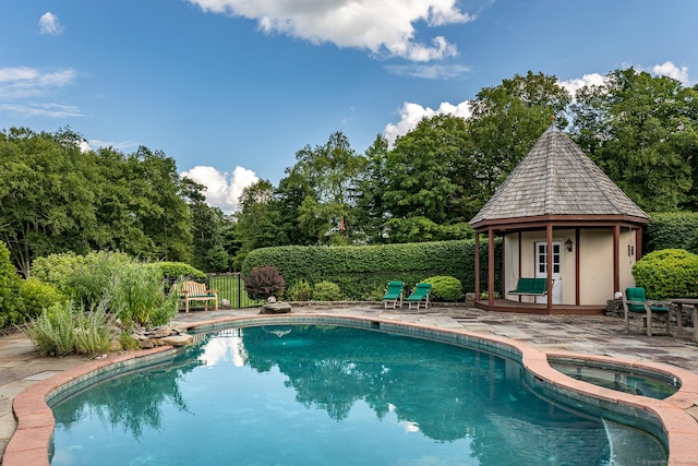 370 Northrop St, Bridgewater, CT 06752 - view of pool with a patio, a pool with connected hot tub, view of wooded area, and an outdoor structure
