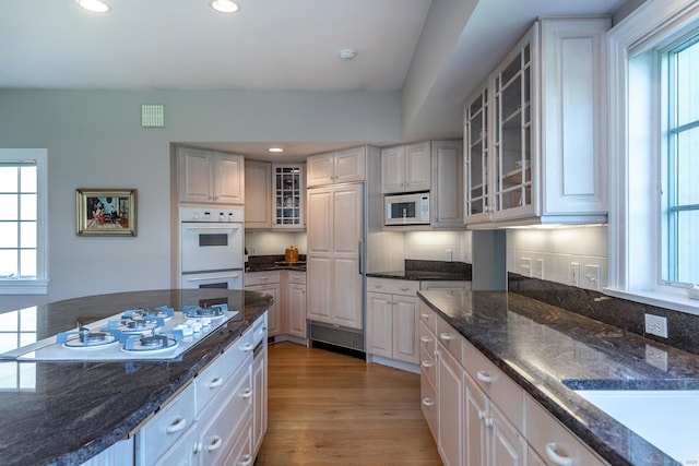 370 Northrop St, Bridgewater, CT 06752 - kitchen with white appliances, light wood-style floors, recessed lighting, glass insert cabinets, and dark stone counters