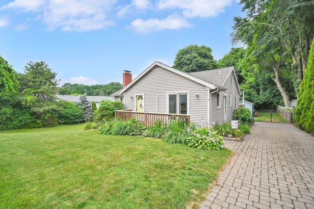 18 Nye St, Vernon, CT 06066 - view of side of home with a chimney, a lawn, and a deck