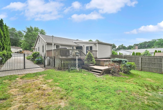 18 Nye St, Vernon, CT 06066 - back of property featuring a hot tub, a deck, a gate, and a fenced backyard
