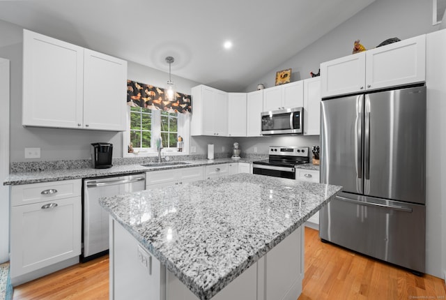 233 W Rd, East Haddam, CT 06420 - kitchen featuring stainless steel appliances, white cabinetry, lofted ceiling, light wood-style floors, and light stone countertops