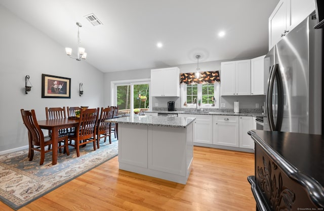 233 W Rd, East Haddam, CT 06420 - kitchen featuring freestanding refrigerator, a chandelier, a kitchen island, white cabinets, and lofted ceiling