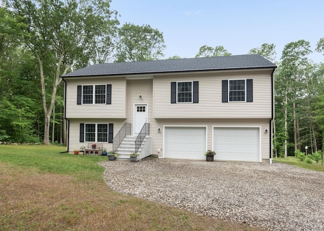 233 W Rd, East Haddam, CT 06420 - split foyer home featuring driveway, a garage, and a front lawn