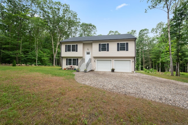 233 W Rd, East Haddam, CT 06420 - raised ranch featuring gravel driveway, a garage, and a front lawn