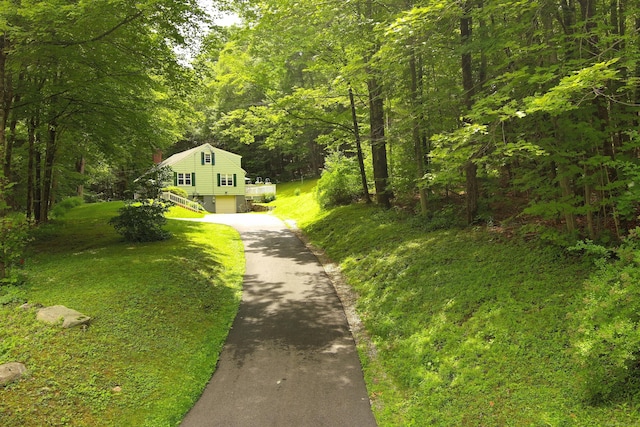 147 Smith Hill Rd, Winchester, CT 06098 - view of front facade featuring asphalt driveway, a view of trees, and a garage