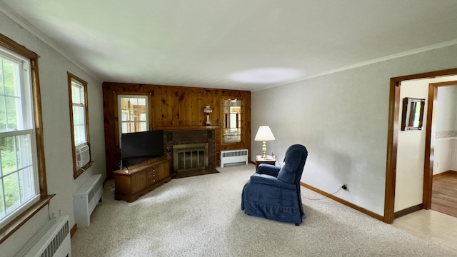 147 Smith Hill Rd, Winchester, CT 06098 - sitting room with radiator, a brick fireplace, ornamental molding, a wall mounted AC, and wooden walls
