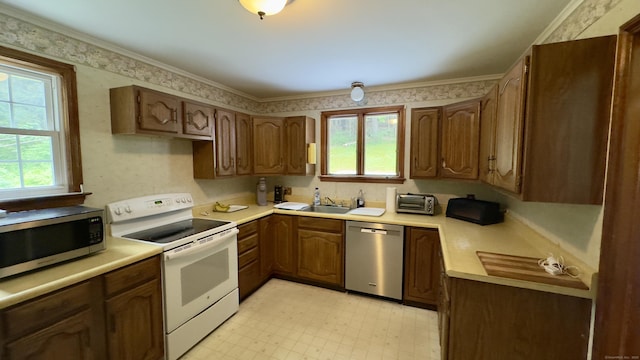 147 Smith Hill Rd, Winchester, CT 06098 - kitchen with appliances with stainless steel finishes, plenty of natural light, light flooring, light countertops, and ornamental molding