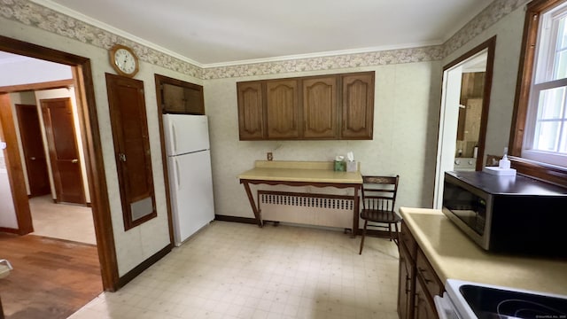 147 Smith Hill Rd, Winchester, CT 06098 - kitchen with freestanding refrigerator, radiator heating unit, stainless steel microwave, light floors, and light countertops