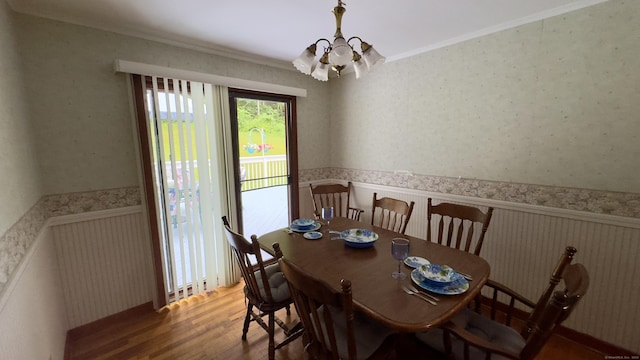 147 Smith Hill Rd, Winchester, CT 06098 - dining room with a chandelier, crown molding, wood finished floors, a wainscoted wall, and wallpapered walls
