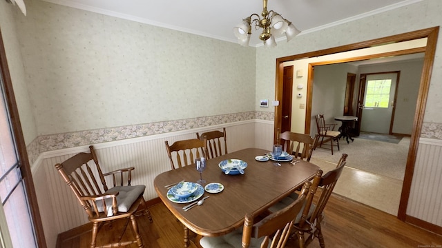 147 Smith Hill Rd, Winchester, CT 06098 - dining space with a chandelier, wood finished floors, a wainscoted wall, wallpapered walls, and crown molding