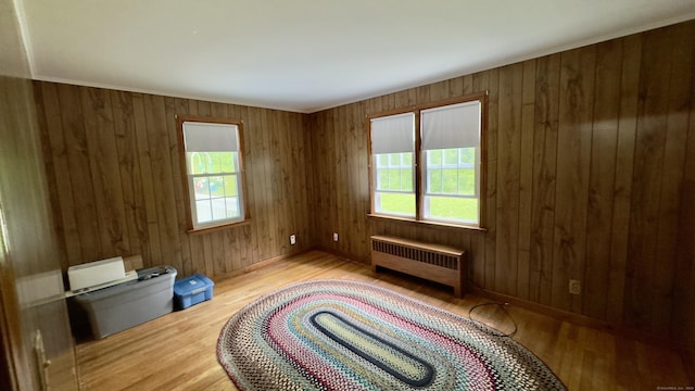 147 Smith Hill Rd, Winchester, CT 06098 - unfurnished bedroom featuring radiator heating unit, wood finished floors, and wooden walls