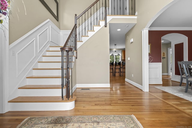 31 Crimson Hts, Portland, CT 06480 - staircase with wood finished floors, arched walkways, ornamental molding, and a high ceiling