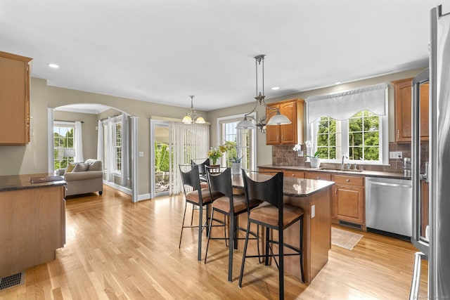 31 Crimson Hts, Portland, CT 06480 - kitchen featuring stainless steel appliances, arched walkways, a breakfast bar area, plenty of natural light, and recessed lighting
