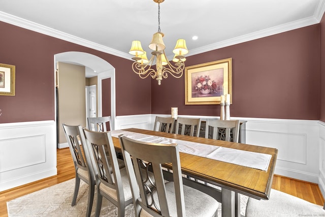 31 Crimson Hts, Portland, CT 06480 - dining room with a chandelier, arched walkways, a wainscoted wall, crown molding, and wood finished floors