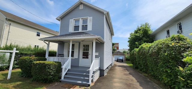 108 School St, Hamden, CT 06518 - view of front of property with covered porch, an outbuilding, a detached garage, and a shingled roof