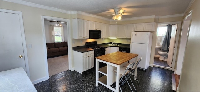 108 School St, Hamden, CT 06518 - kitchen with black appliances, ceiling fan, plenty of natural light, dark flooring, and crown molding