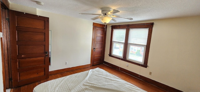 108 School St, Hamden, CT 06518 - bedroom featuring dark wood finished floors, a textured ceiling, and ceiling fan