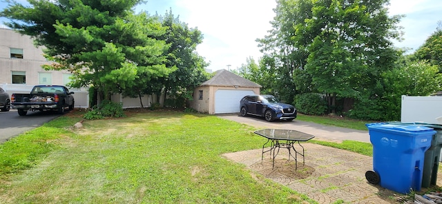108 School St, Hamden, CT 06518 - view of grassy yard featuring an outdoor structure, driveway, and a garage