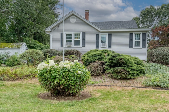 6 Rau Street Ext, Vernon, CT 06066 - view of front of property featuring a chimney, roof with shingles, cooling unit, and a front lawn